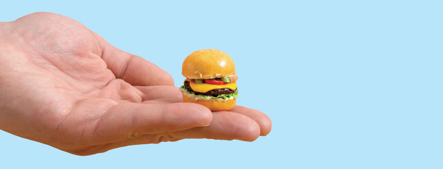 Image of a hand holding a tiny cheeseburger